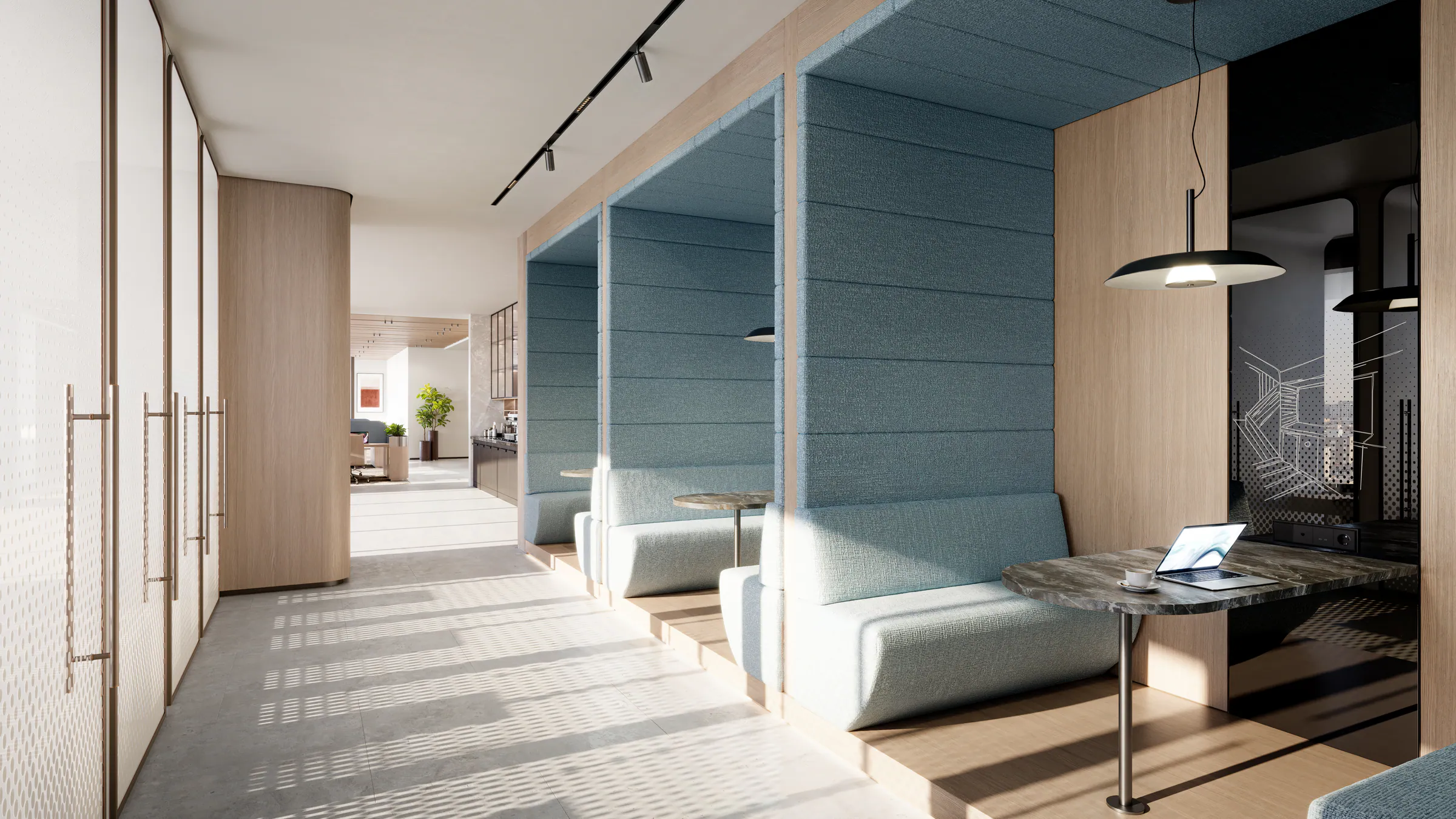 Co-working booths with upholstered seating and a laptop