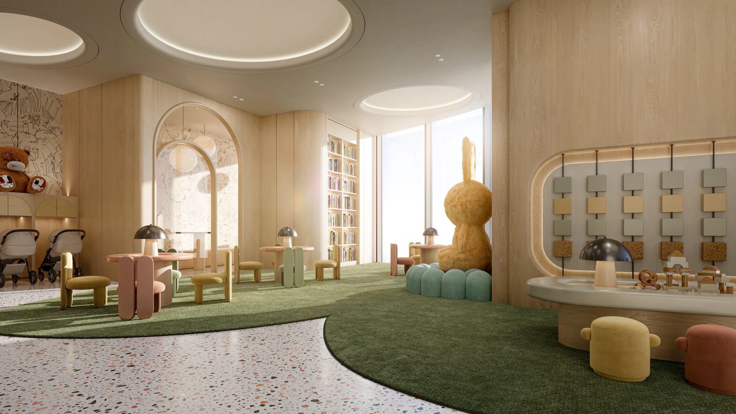 Kids club with play walls, small tables and a soft green floor