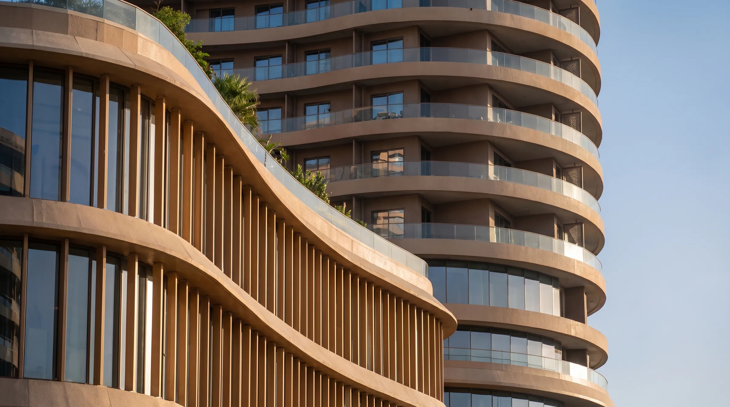 The curved bands of Burj Urubah’s podium meeting the tower