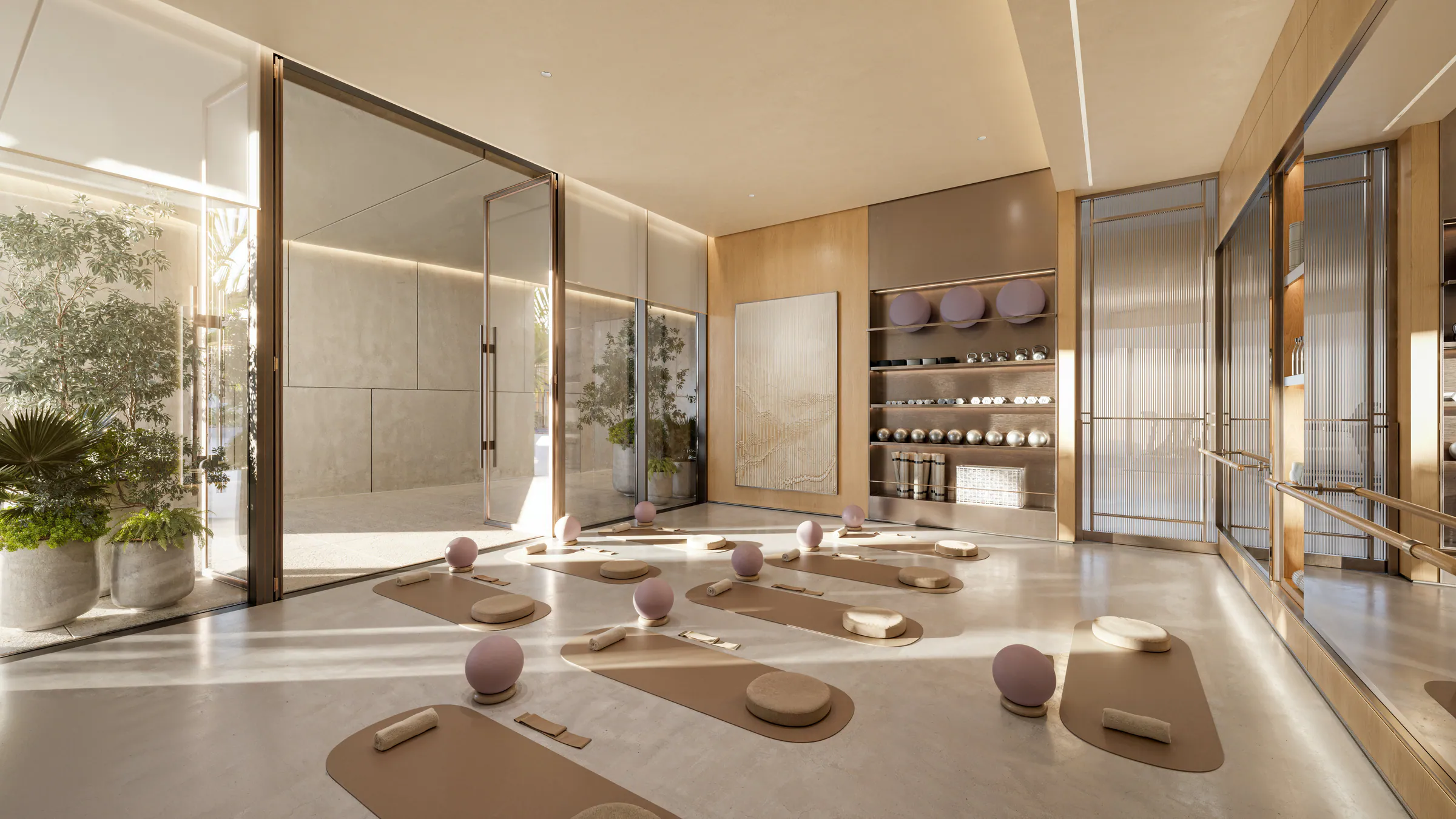 A training studio with mats and soft daylight behind glass