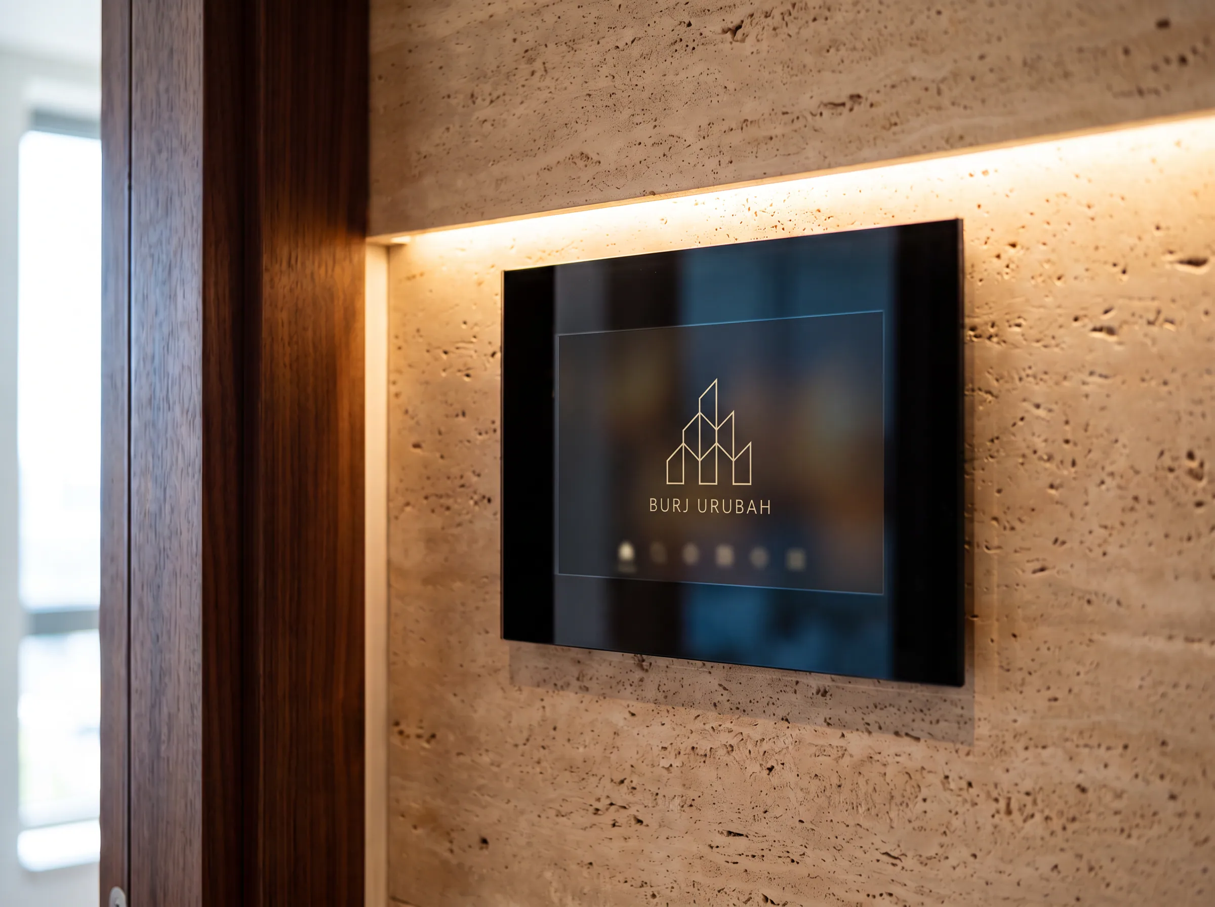 A video intercom screen showing the Burj Urubah mark on a travertine wall